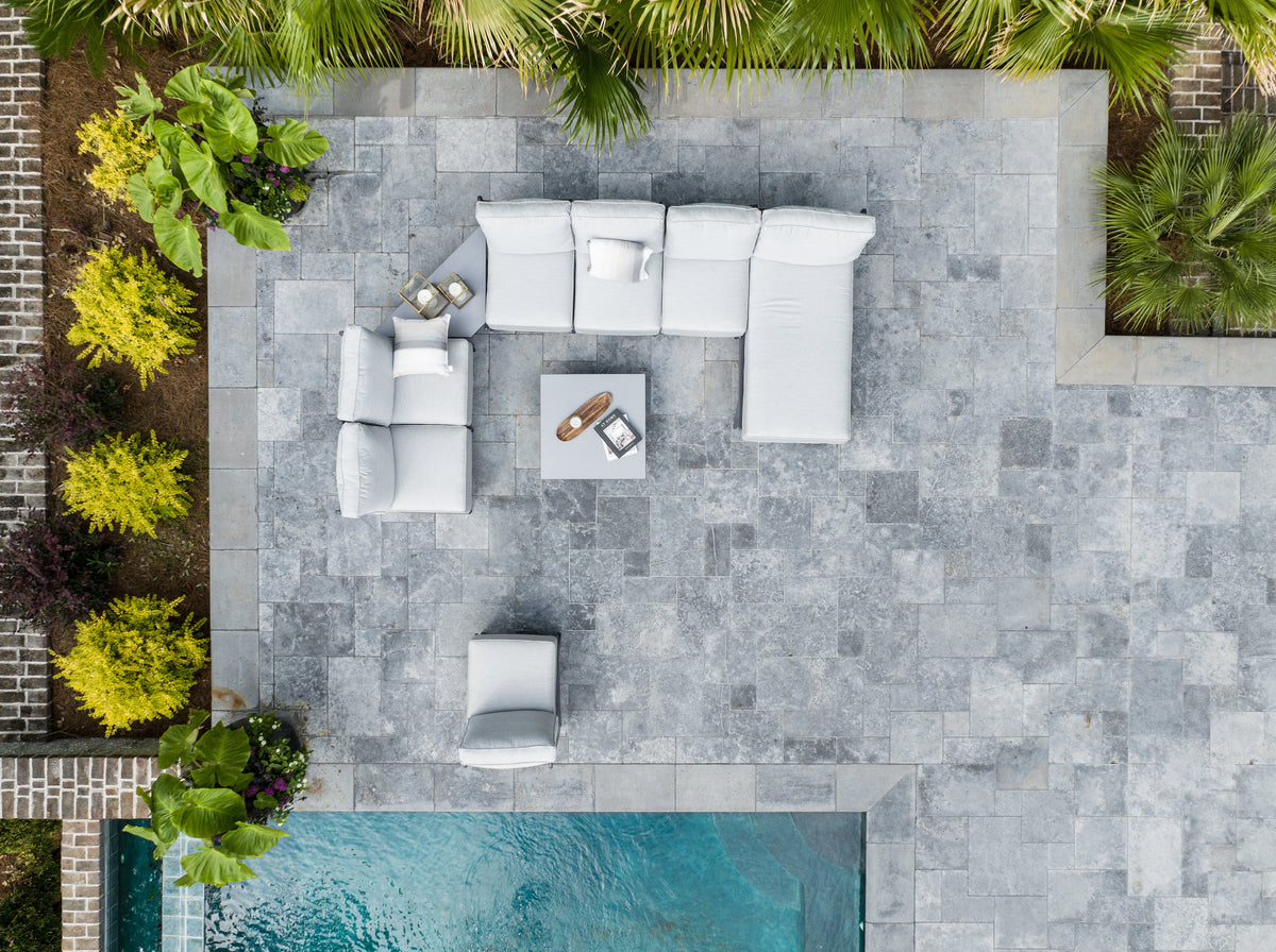 Outdoor sofa, loveseat, chaise lounge and club chair set on a patio