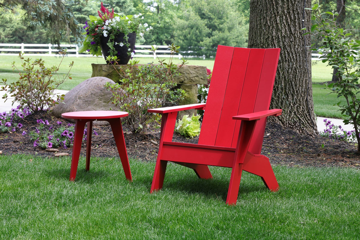 Outdoor round end table beside an Adirondack chair