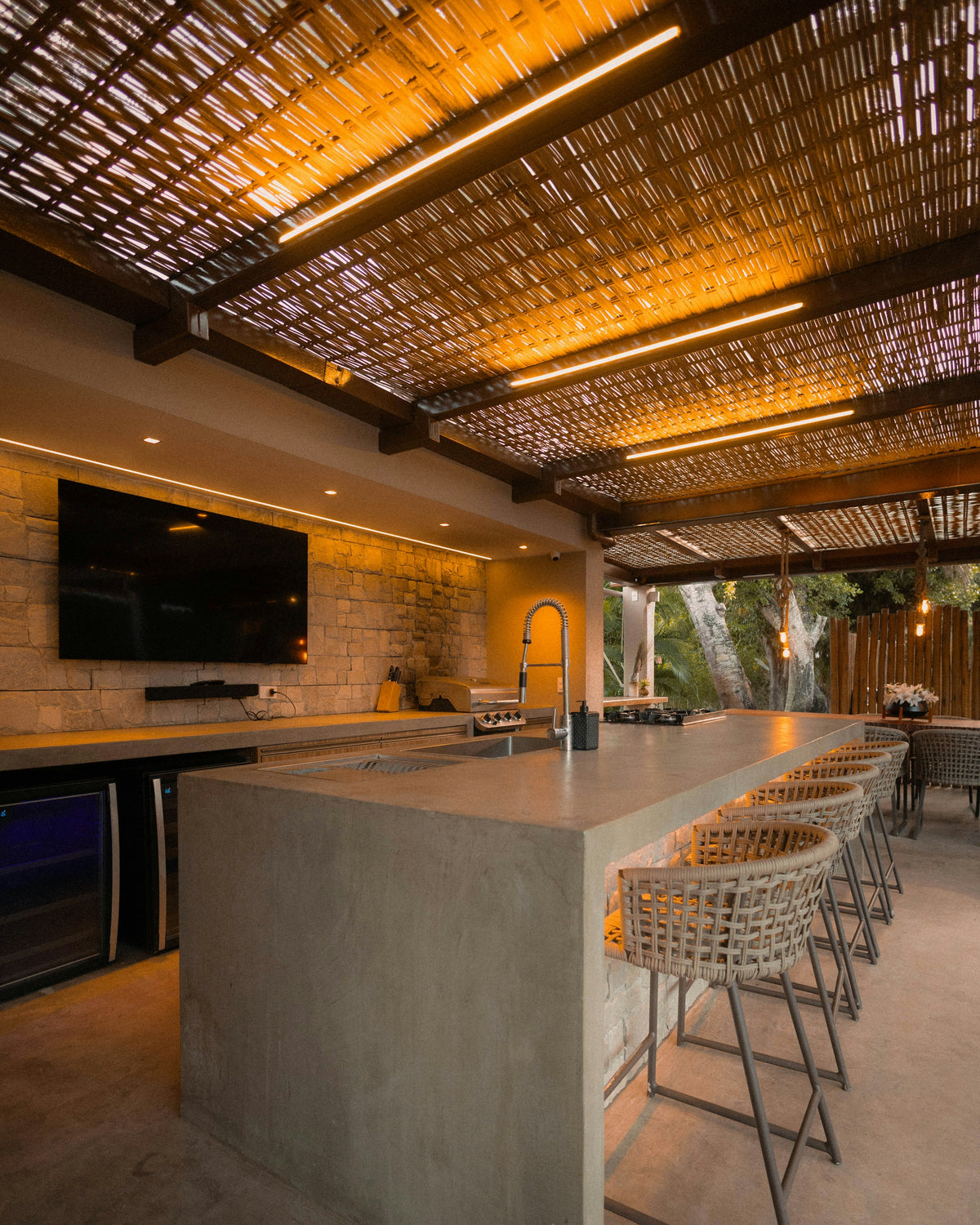 Modern outdoor kitchen with bar and seating